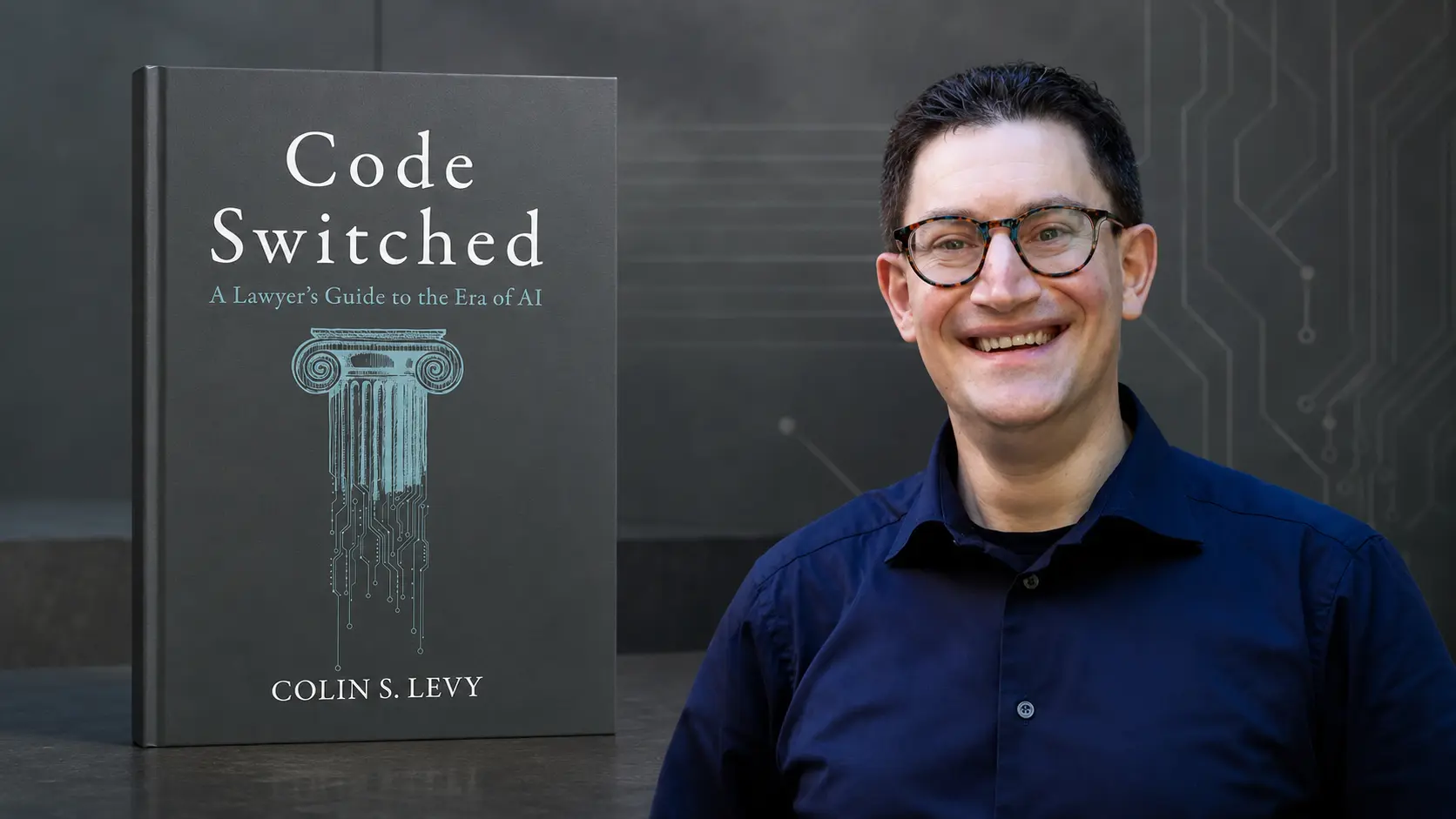 Colin S Levy next to the cover of his book Code Switched